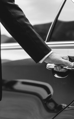 businessman handle limousine door car